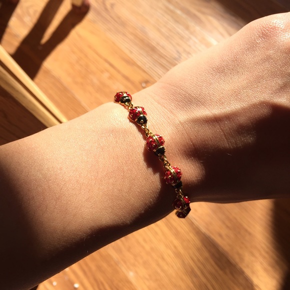 Joan Rivers lady bug bracelet.