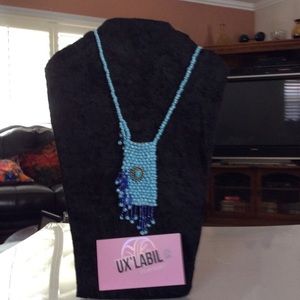 Turquoise lipstick holder necklace.
