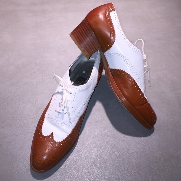 Golf style wing- tipped women shoes.