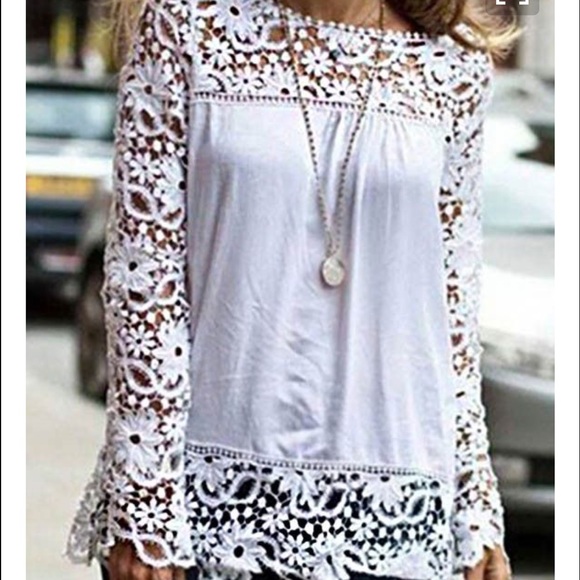 White shear blouse with lace sleeves.