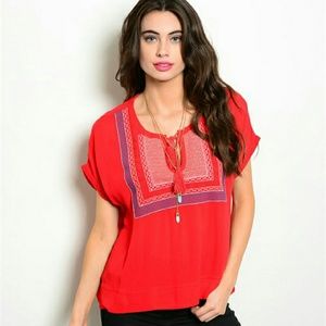 Red peasnt top with white and blue embroidery