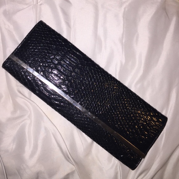 Black snakeskin clutch with silver trim like new