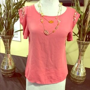 A peach color bedazzled sleeve blouse