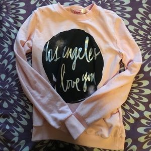 Pink sweater that says "los Angeles I love you"