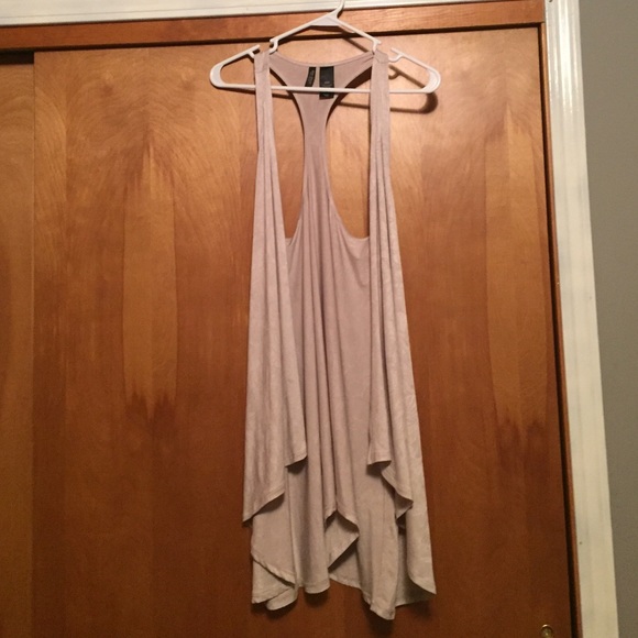 Tan tank top over shirt. Overs the butt.