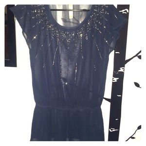 Sheer navy blouse with jeweled neckline.