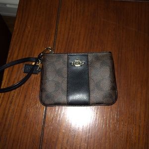 Brown leather coach wristlet with dark brown Cs
