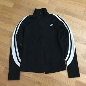 Black Nike jacket with white stripes on sleeves