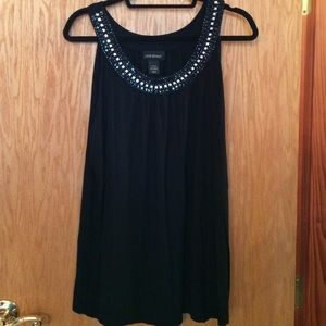 Black sleeveless top with studded detail at neck.