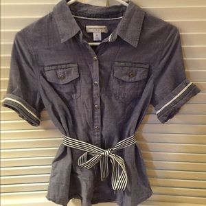 Jean colored button down shirt.