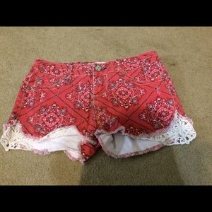 Red Paisley denim shorts with lace detail.