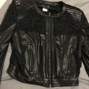 A black leather high waist jacket .