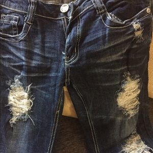 Blue distressed jeans with rhinestone accent