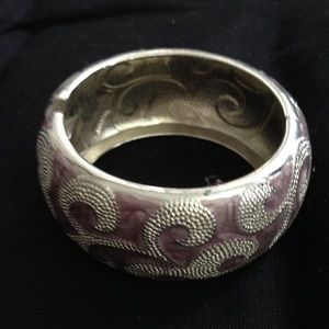 Silver tone light pink bangle with swirl design