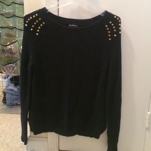 Black knit sweater with gold studs on shoulder