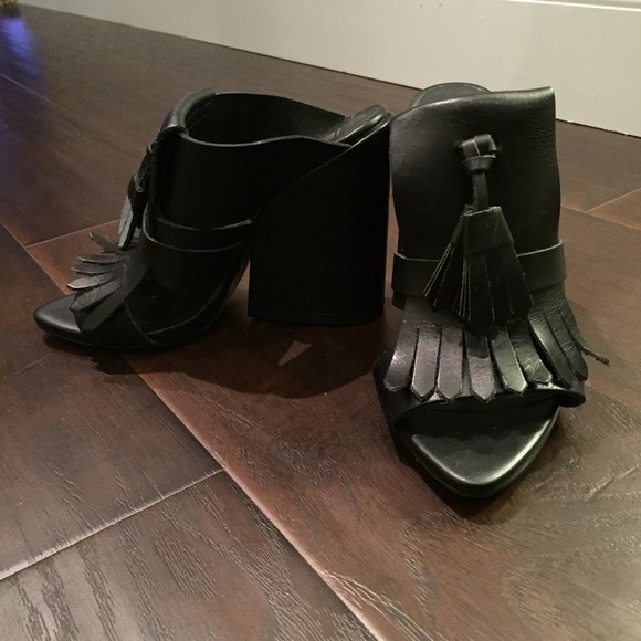 Fashion forward black leather mules with tassel