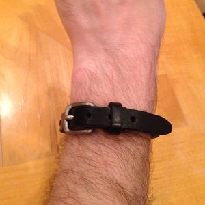 Black leather bracelet, silver buckle.