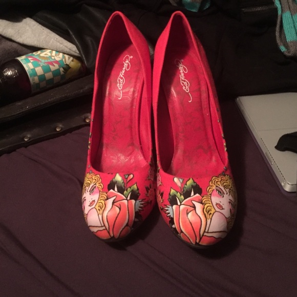 Red high heels with blonde girl and flowers.