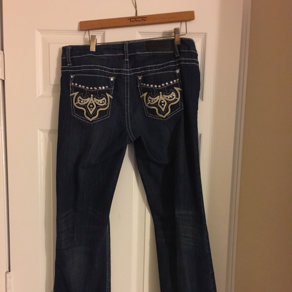 Blue jeans with faux leather design.