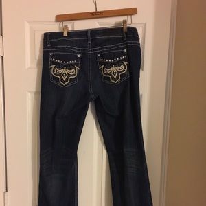 Blue jeans with faux leather design.