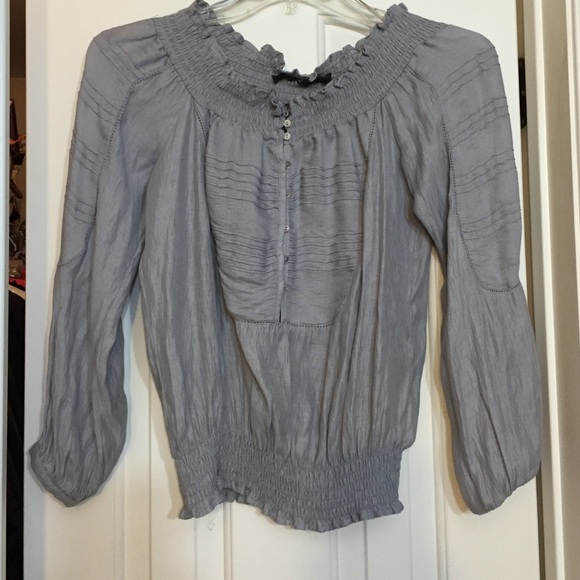Cute top with detailed front and gathered bottom.