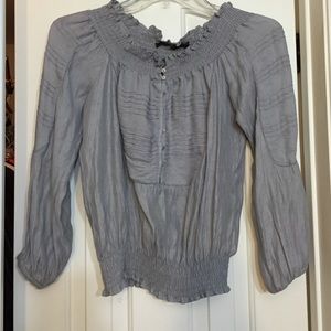 Cute top with detailed front and gathered bottom.