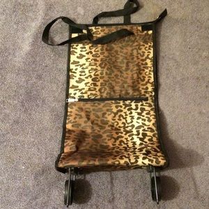 Collapsible and rolling cheetah print travel bag.