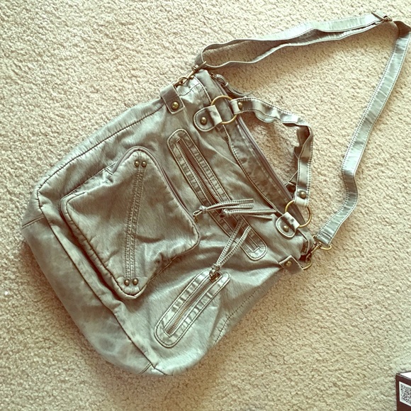 Across the shoulder Maurice's handbag.