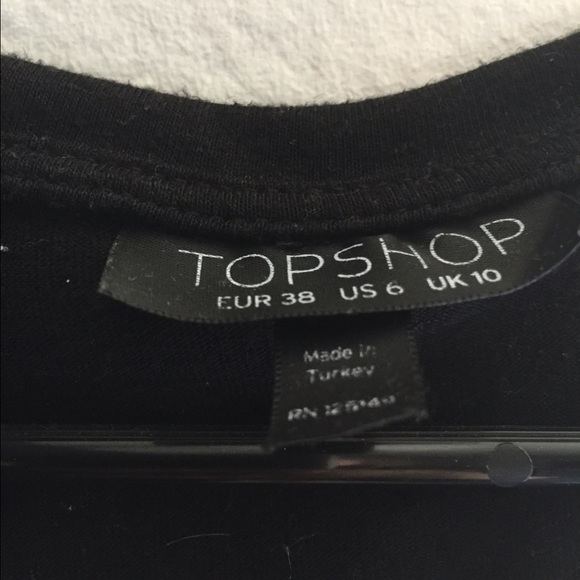 A black shirt with cut outs at the buttom