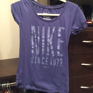 Purple/blue Nike Tshirt with light blue writing.
