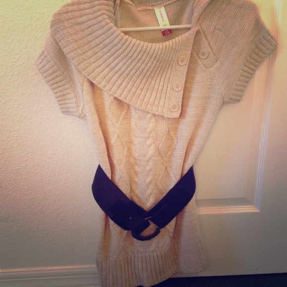 Cream colored top with belt .