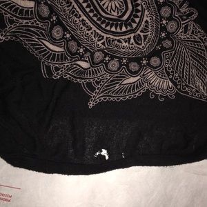 Hole in black muscle tee