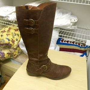 Tall brown boots with metal accents