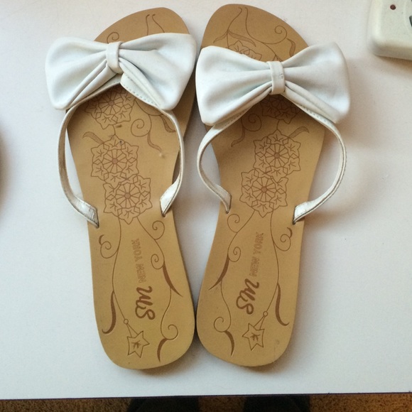 Gently worn white flip flops with bows!