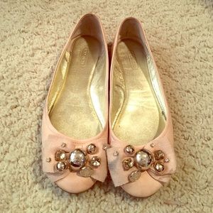 Pretty in pink Coach flats.