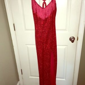 Stunning red sequins dress with high slit.