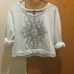 Midriff sweater top. Light blue with design.