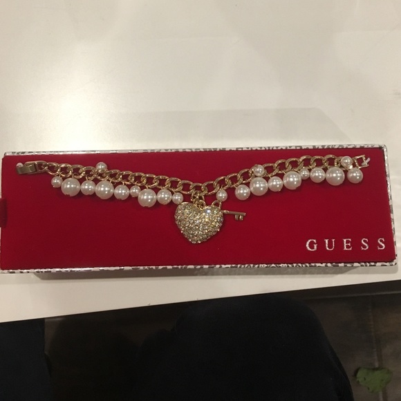 Guess bracelet with heart and key locket.