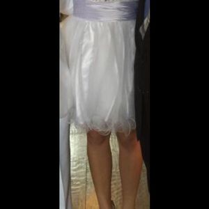 White, short party dress with stone embellishment.
