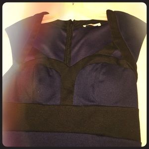 Navy blue knee length dress with no sleeves.