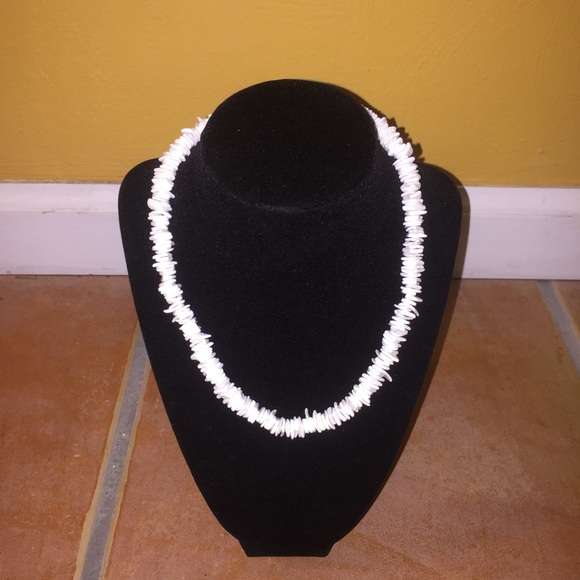 White necklace made entirely of seashells.