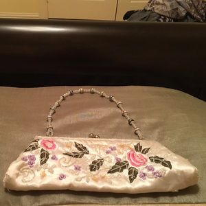 Small white purse with flowers and leaves on it
