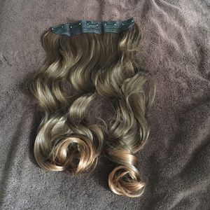 Light brown curled extensions.