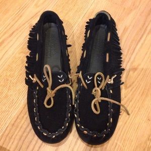 Black fringe Minnetonka moccasins with brown laces