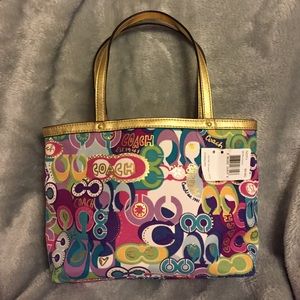 Multi color COACH tote with gold trim.