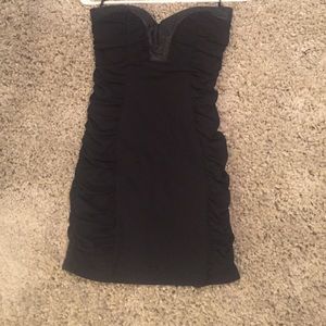 Black strapless dress. Exposed zipper.