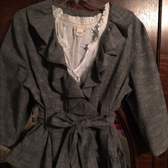 Gray jacket with self belt and ruffle detail.