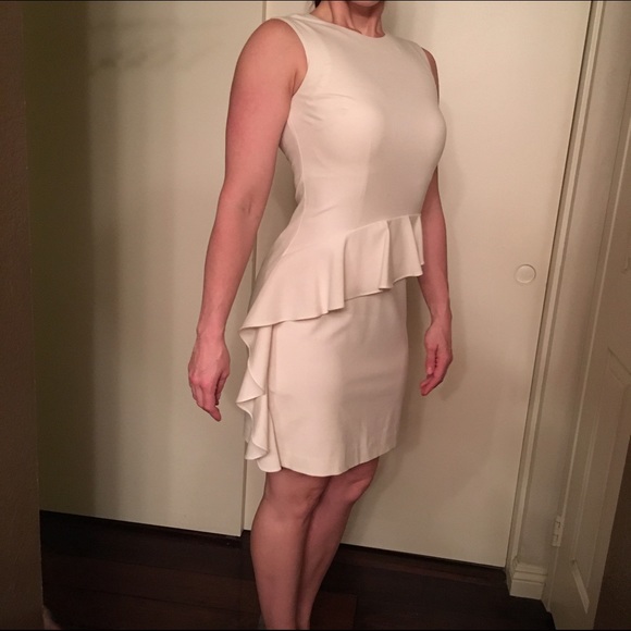 Sleeveless Cream ruffle dress with back zip.