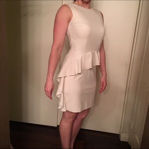 Sleeveless Cream ruffle dress with back zip.