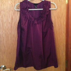 Purple top with ruffle neck.